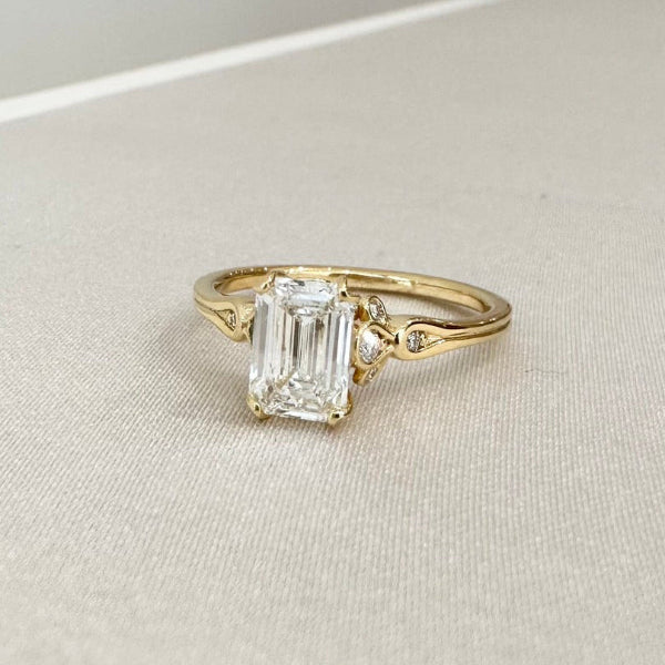 DDS訂製婚戒－黃K金祖母綠形主鑽求婚戒，細節雕飾設計呈現復古典雅風格